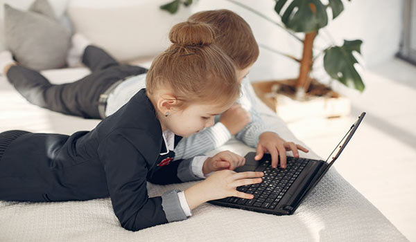 boy and a girl on a computer